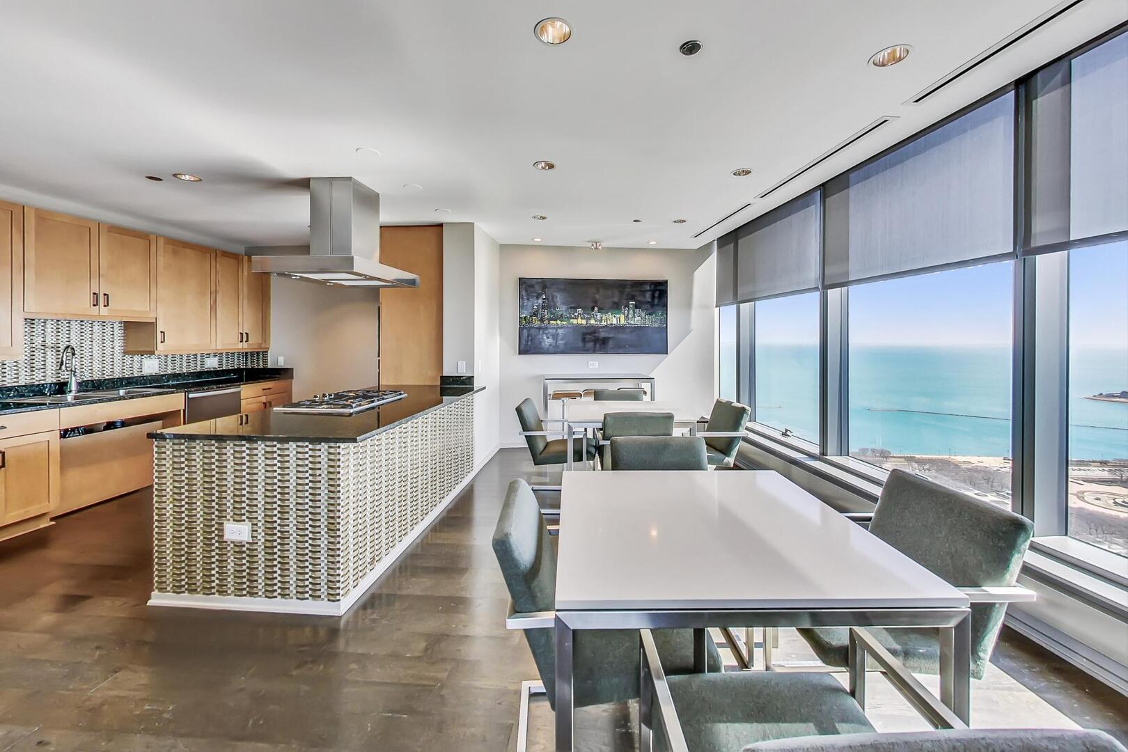 60 East Monroe Street, Unit 5103 Chicago, IL 60603 - Photo 40 of 63 a view of a dining room with furniture a chandelier and wooden floor