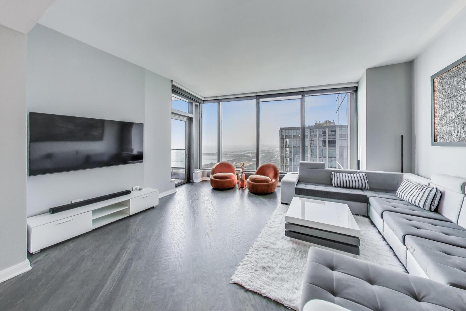 60 East Monroe Street, Unit 5103 Chicago, IL 60603 - Photo 7 of 63 a living room with furniture and a flat screen tv
