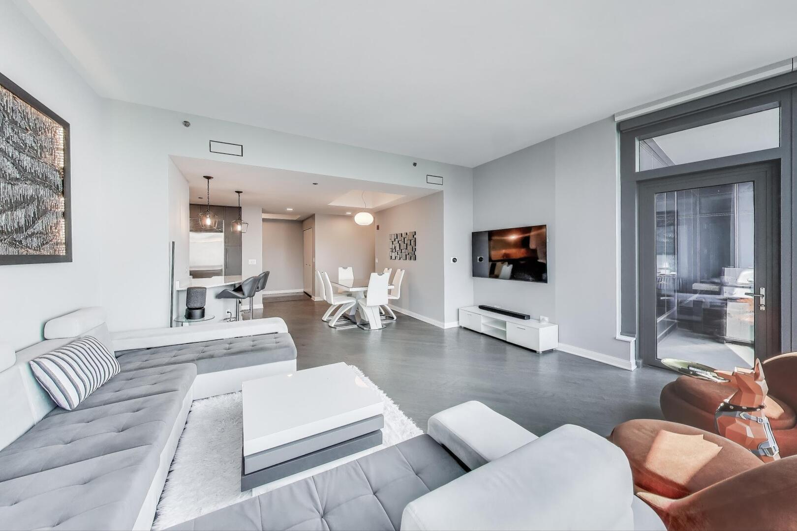 60 East Monroe Street, Unit 5103 Chicago, IL 60603 - Photo 9 of 63 a living room with furniture and a flat screen tv