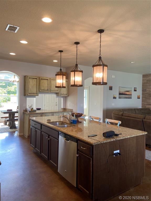 1900 Marsh Road DeLand, FL 32724 - Photo 12 of 39 a kitchen that has a stove a sink a counter space and a window