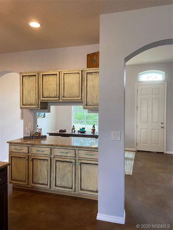 1900 Marsh Road DeLand, FL 32724 - Photo 13 of 39 a kitchen with stainless steel appliances granite countertop a stove a sink and a microwave