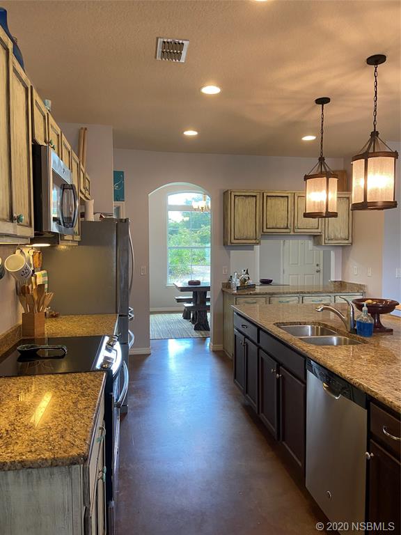 1900 Marsh Road DeLand, FL 32724 - Photo 14 of 39 a kitchen with sink stove and cabinets