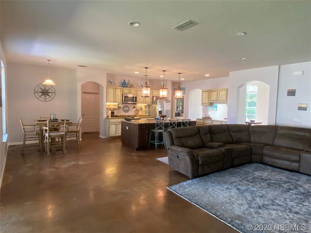 1900 Marsh Road DeLand, FL 32724 - Photo 16 of 39 a living room with furniture and kitchen view