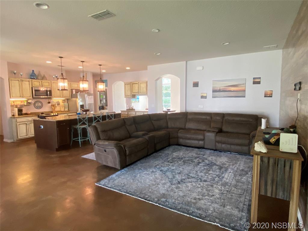 1900 Marsh Road DeLand, FL 32724 - Photo 17 of 39 a living room with couches and kitchen view with wooden floor
