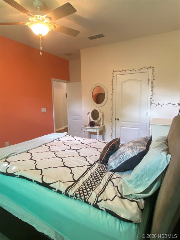 1900 Marsh Road DeLand, FL 32724 - Photo 18 of 39 a bedroom with a bed and a chandelier