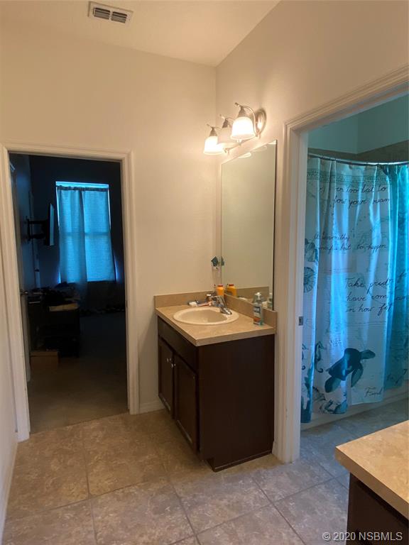1900 Marsh Road DeLand, FL 32724 - Photo 20 of 39 a bathroom with a sink and a mirror