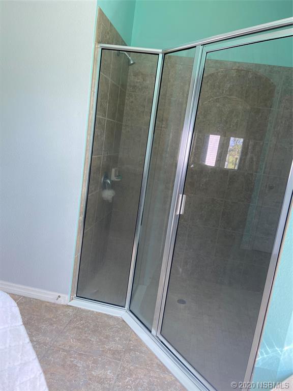 1900 Marsh Road DeLand, FL 32724 - Photo 27 of 39 a bathroom with a glass door shower and vanity