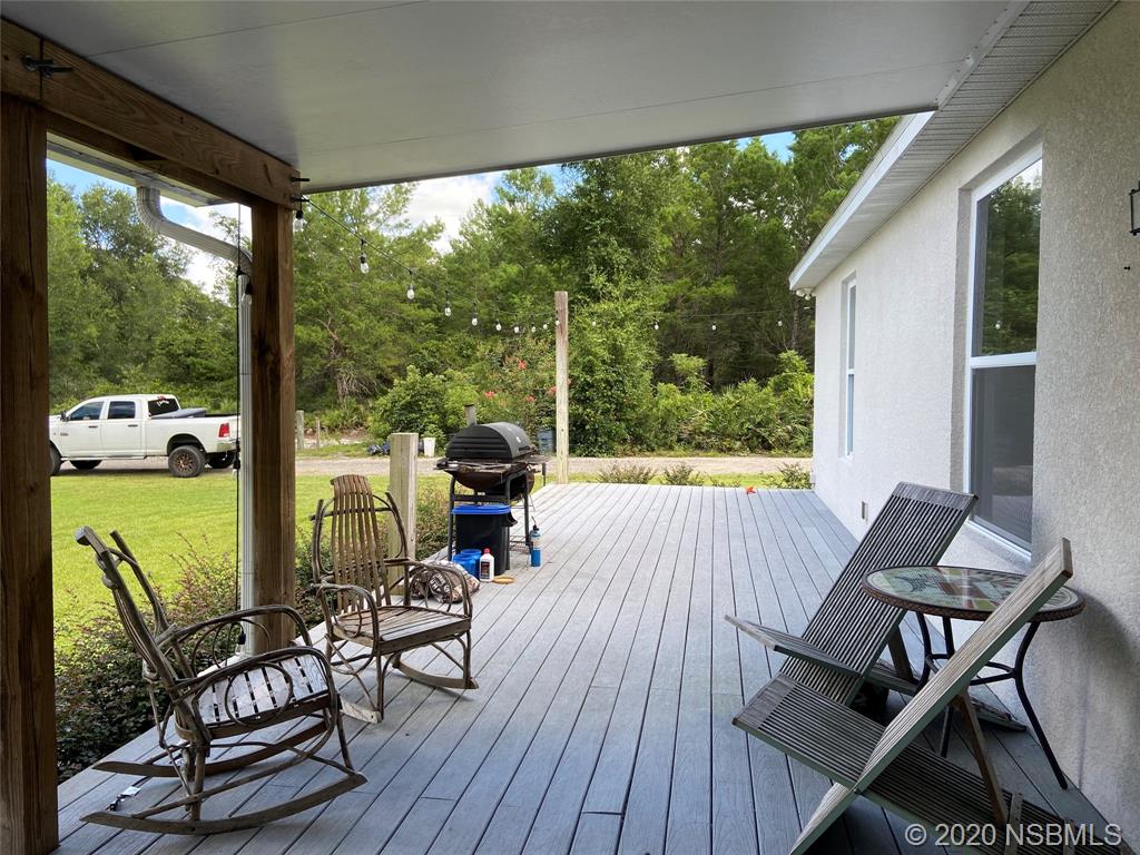 1900 Marsh Road DeLand, FL 32724 - Photo 33 of 39 a view of a patio with table and chairs and wooden floor