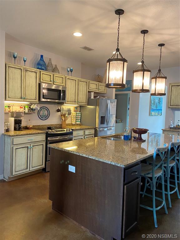 1900 Marsh Road DeLand, FL 32724 - Photo 10 of 39 a kitchen with stainless steel appliances granite countertop a sink a stove and a wooden floors