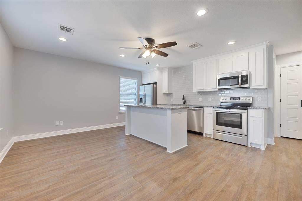 1713 Bronco Road Granbury, TX 76049 - Photo 1 of 23 Open-concept living space featuring wood-finish flooring, recessed lighting, and a ceiling fan