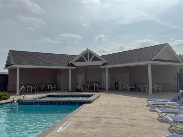 a view of a house with swimming pool and porch
