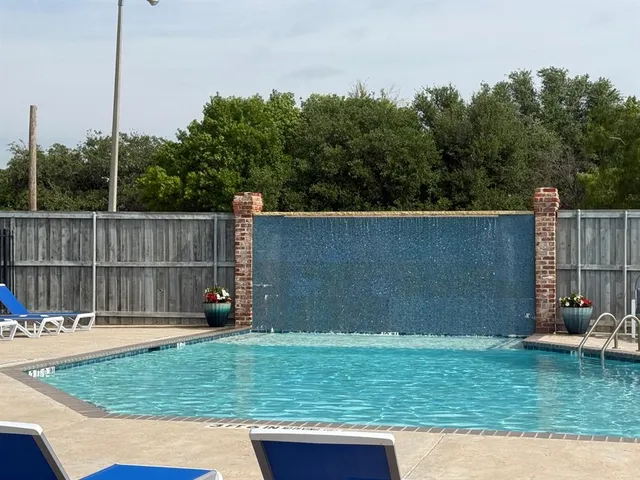 a view of a backyard with a sitting area and barbeque grill