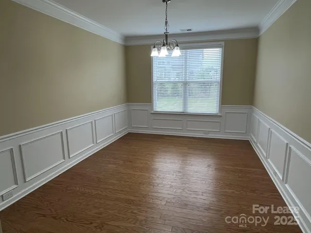 a large kitchen with stainless steel appliances granite countertop a stove a sink and a refrigerator