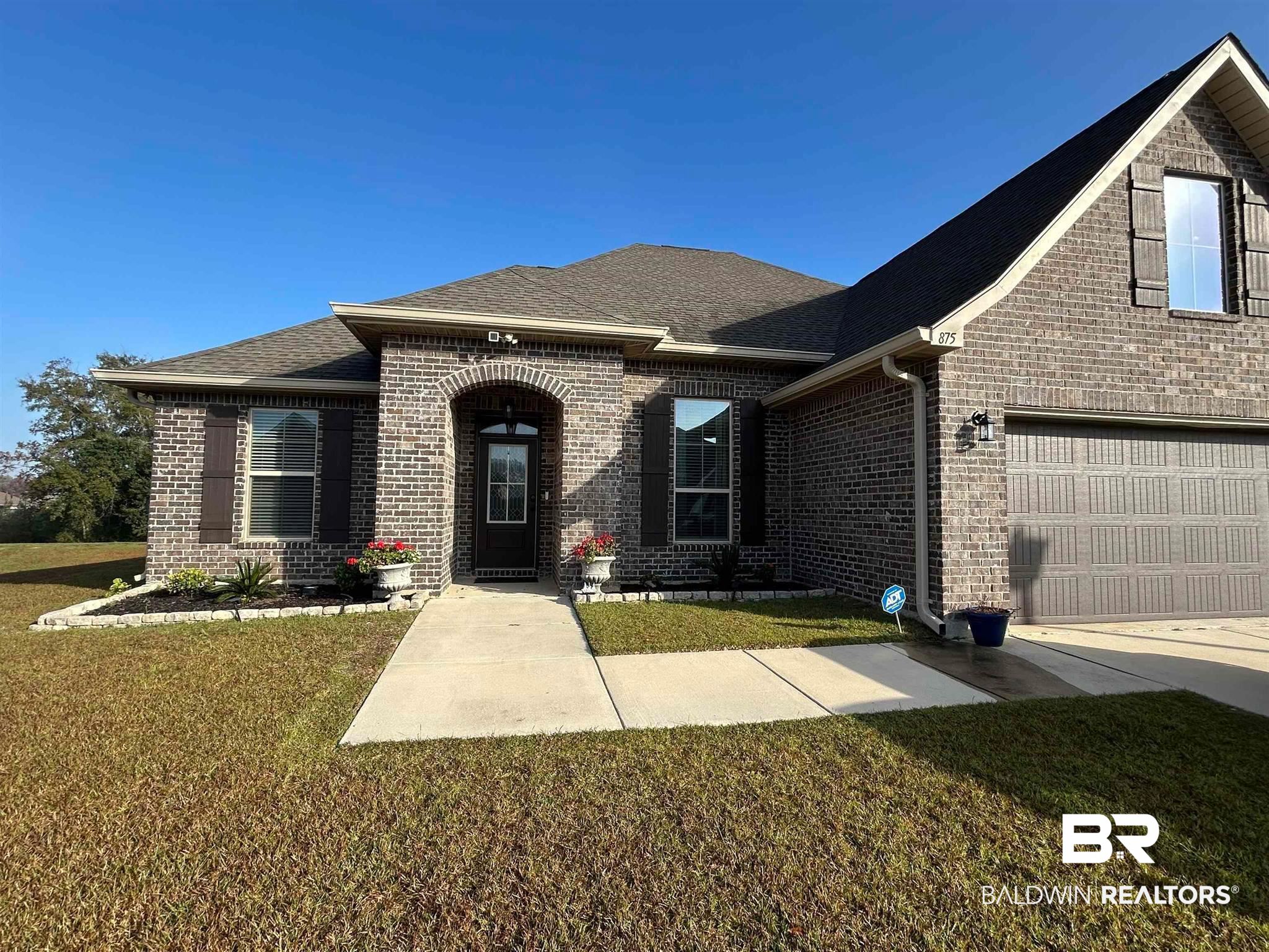 875 Connolly Avenue Foley, AL 36535 - Photo 1 of 1 View of front of property with brick siding, a shingled roof, and a front lawn