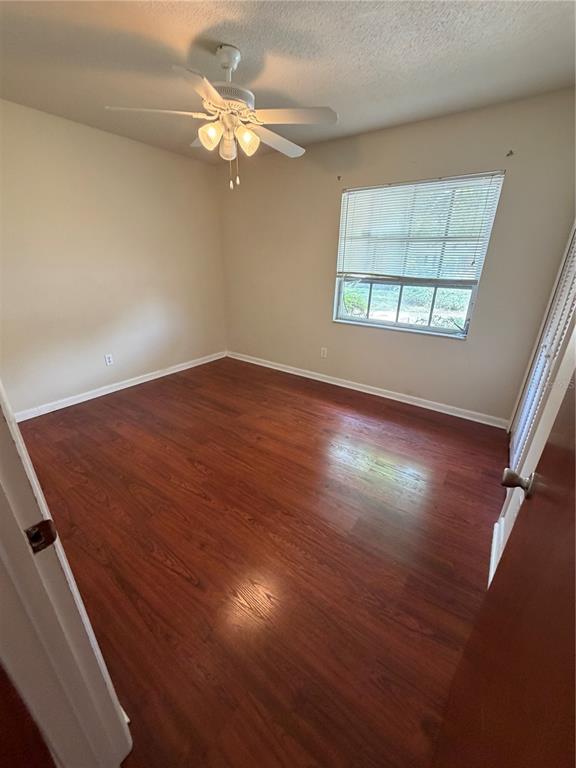 517 London Road Winter Park, FL 32792 - Photo 10 of 13 an empty room with wooden floor chandelier fan and windows