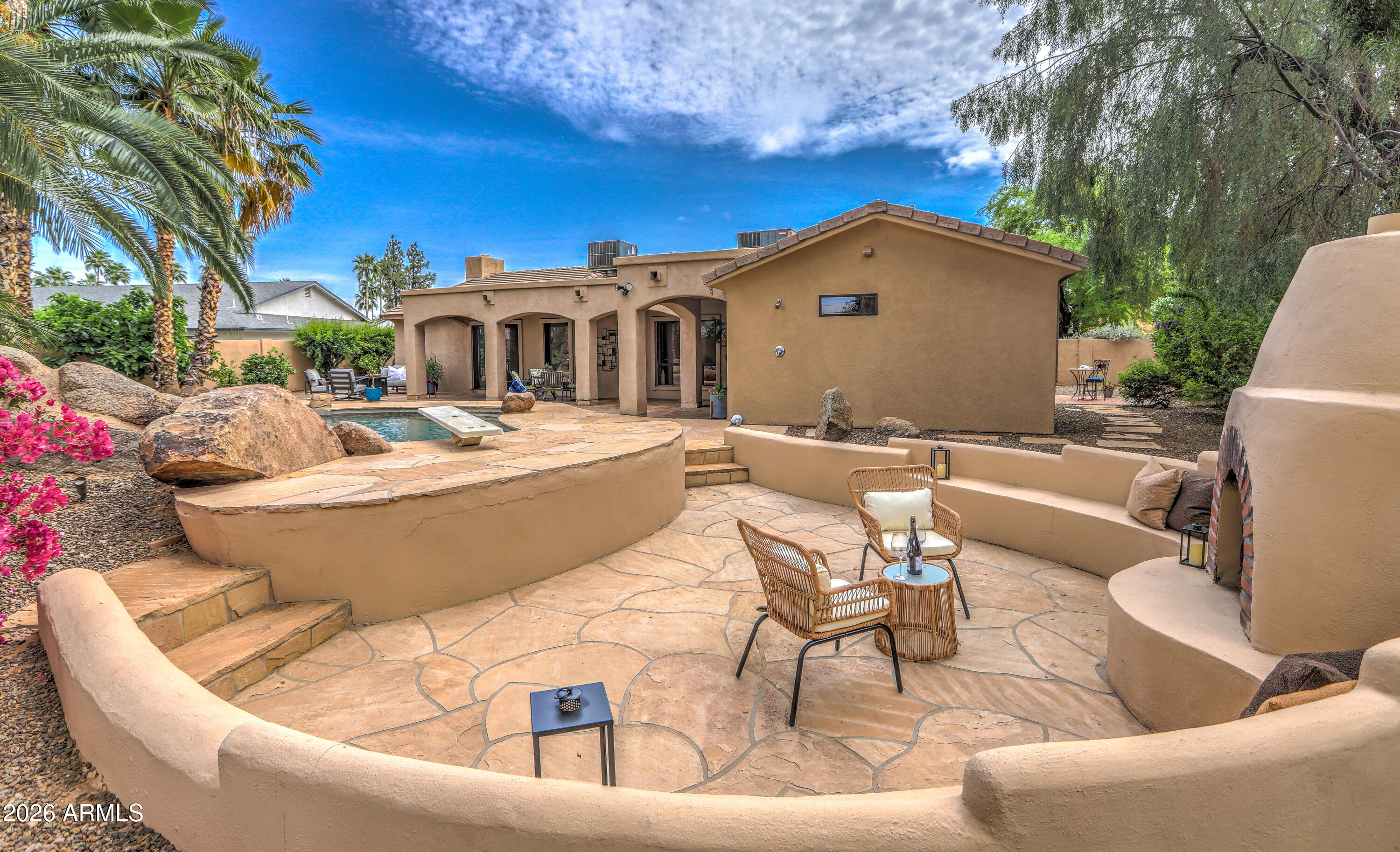 7414 East Corrine Road Scottsdale, AZ 85260 - Photo 20 of 67 a view of a patio with couches table and chairs and potted plants