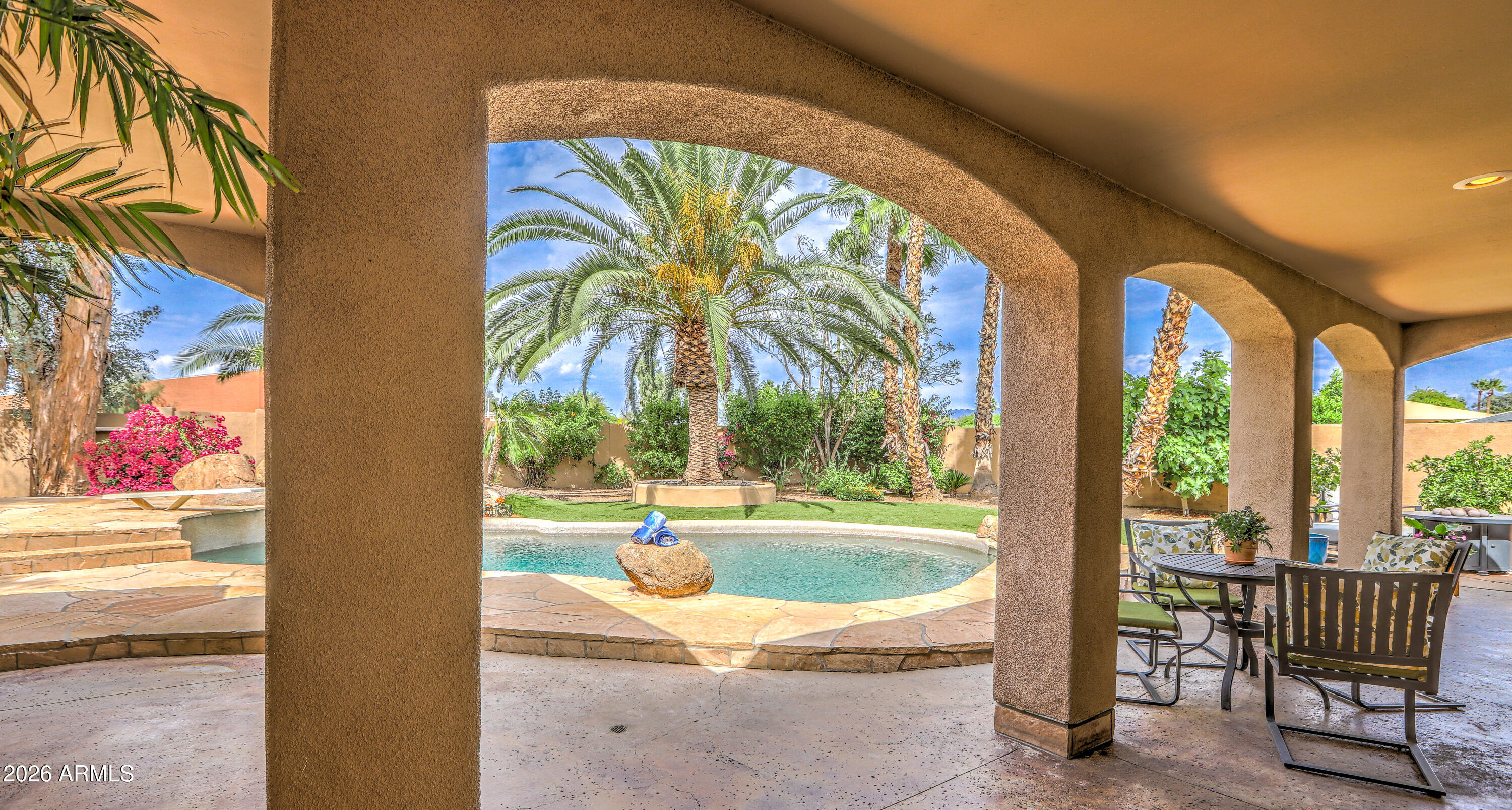 7414 East Corrine Road Scottsdale, AZ 85260 - Photo 23 of 67 a view of swimming pool with a sitting space