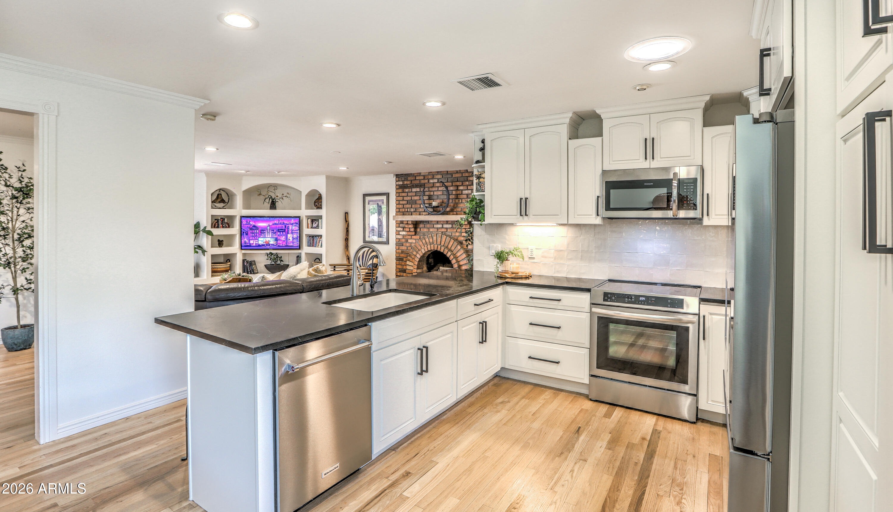 7414 East Corrine Road Scottsdale, AZ 85260 - Photo 28 of 67 a kitchen with stainless steel appliances granite countertop a stove top oven a sink and a refrigerator