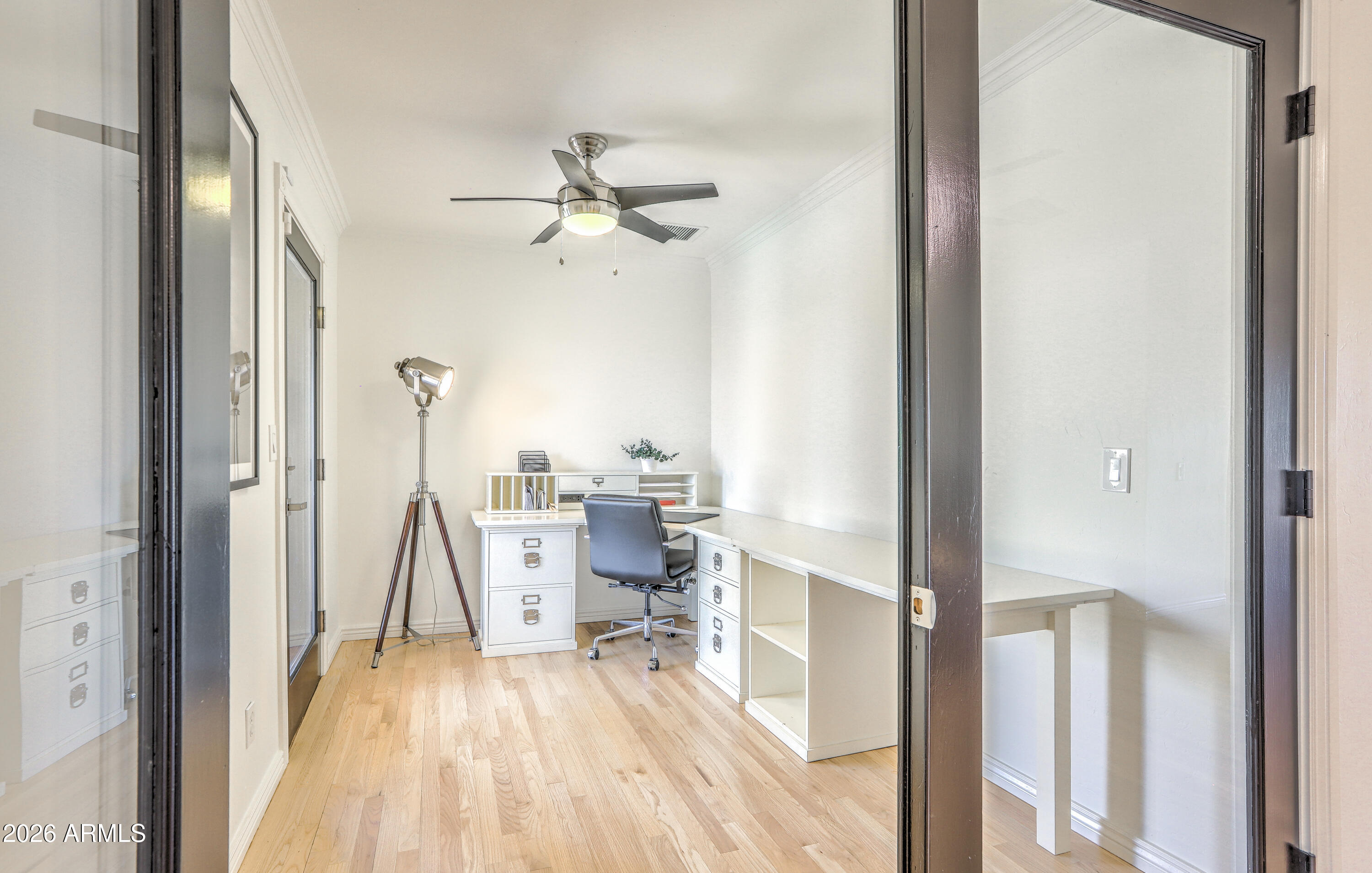 7414 East Corrine Road Scottsdale, AZ 85260 - Photo 41 of 67 a view of a bedroom with wooden floor table and chairs