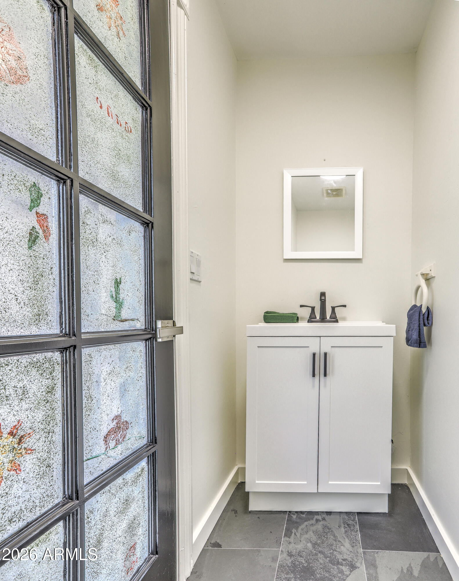 7414 East Corrine Road Scottsdale, AZ 85260 - Photo 52 of 67 a bathroom with a sink mirror and window