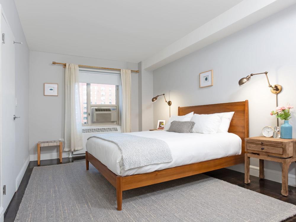 8 Peter Cooper Road, Unit 1A Manhattan, NY 10010 - Photo 4 of 10 a bedroom with a bed lamp and a window