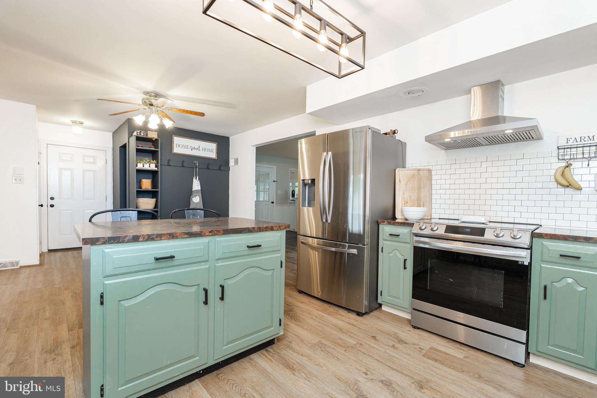 1414 Kitchens Orchard Falling Waters, WV 25419 - Photo 24 of 55 a kitchen with stainless steel appliances a stove refrigerator and microwave