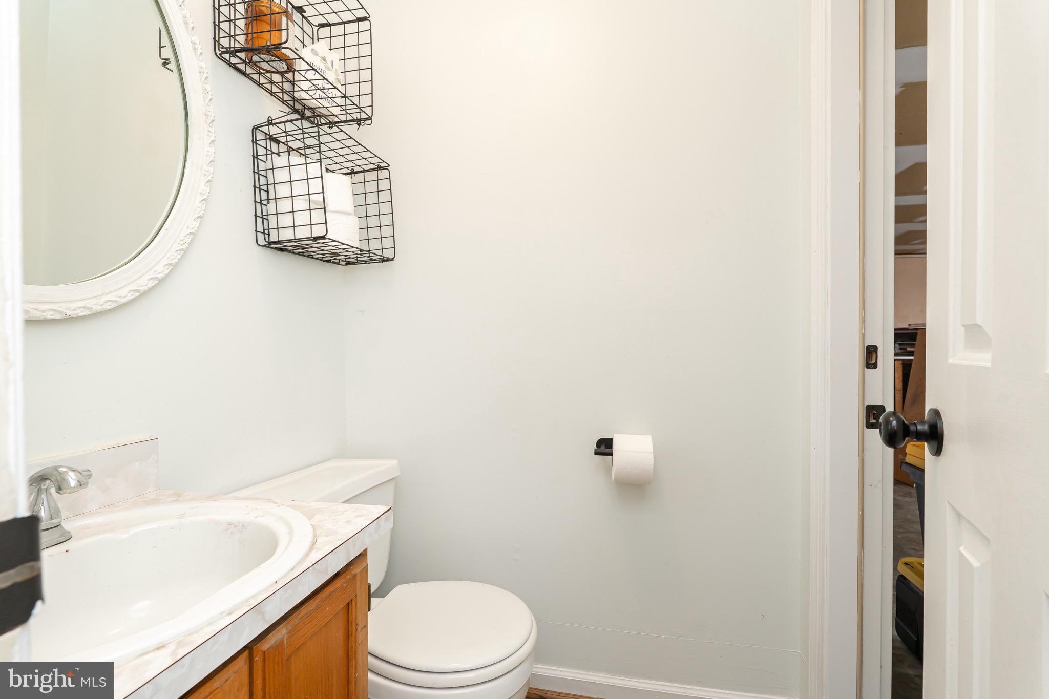 1414 Kitchens Orchard Falling Waters, WV 25419 - Photo 30 of 55 a white toilet sitting next to a bathroom sink and vanity