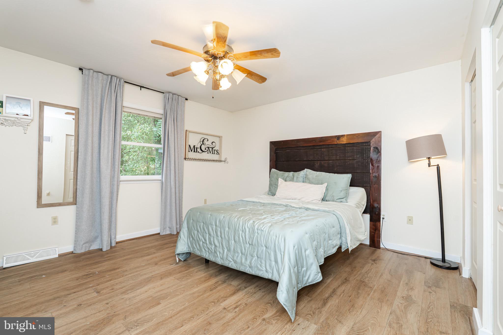 1414 Kitchens Orchard Falling Waters, WV 25419 - Photo 40 of 55 a bedroom with a large bed chandelier and a window