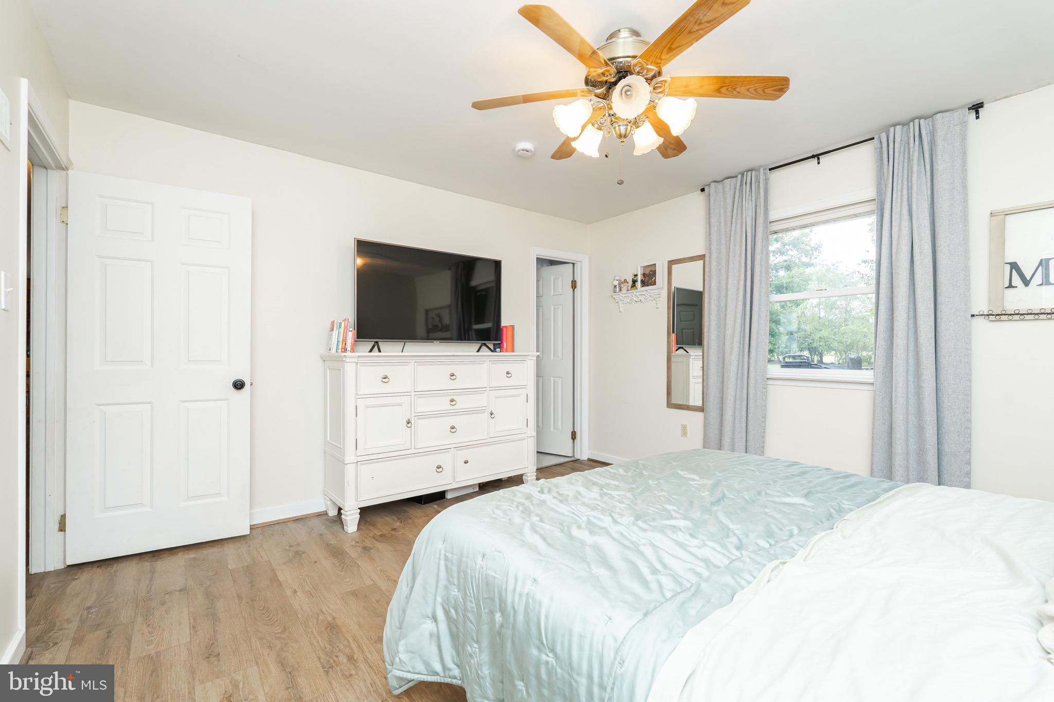 1414 Kitchens Orchard Falling Waters, WV 25419 - Photo 42 of 55 a bedroom with a bed tv and wooden floor