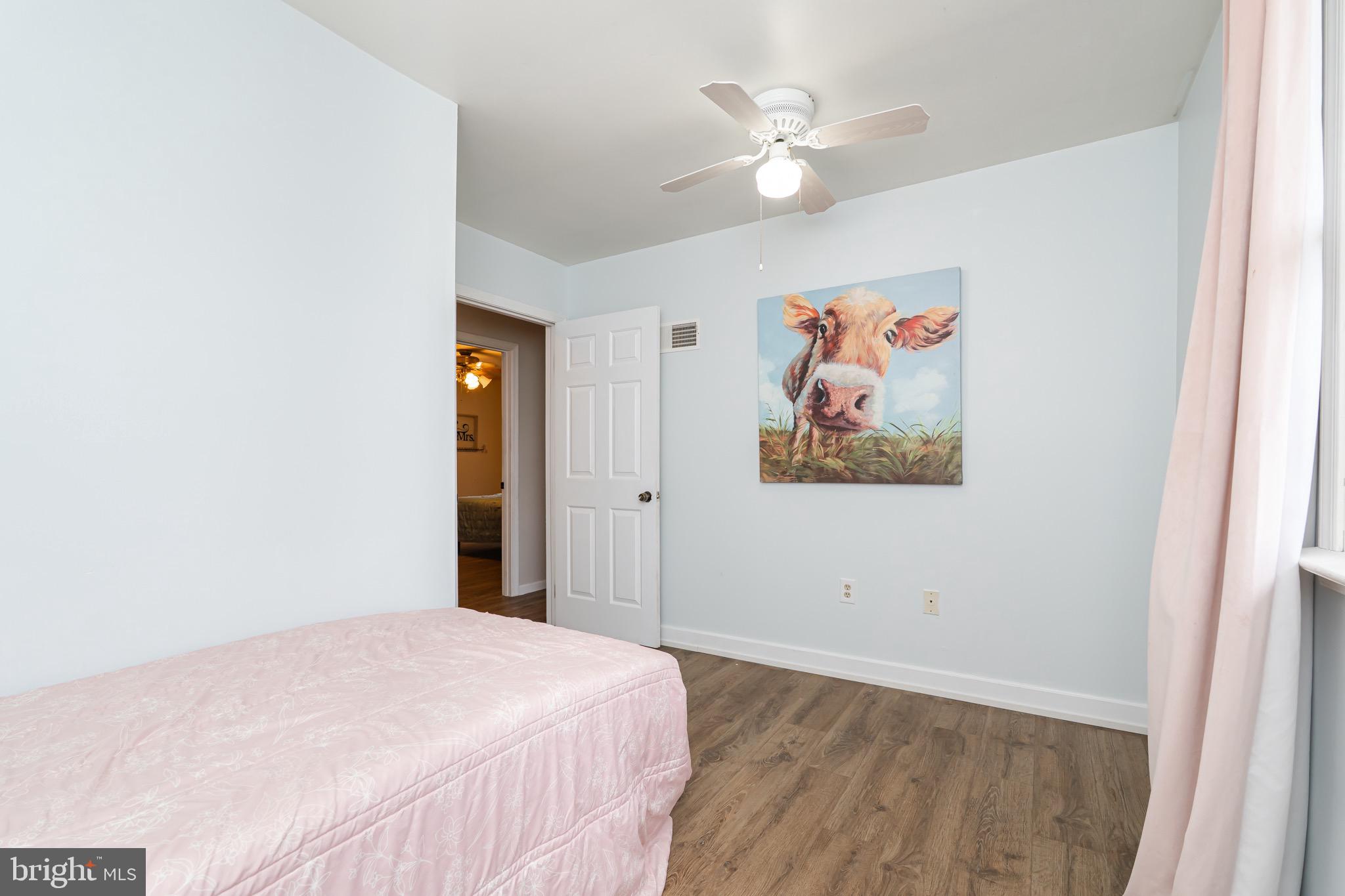 1414 Kitchens Orchard Falling Waters, WV 25419 - Photo 47 of 55 a bedroom with a large bed and a chandelier