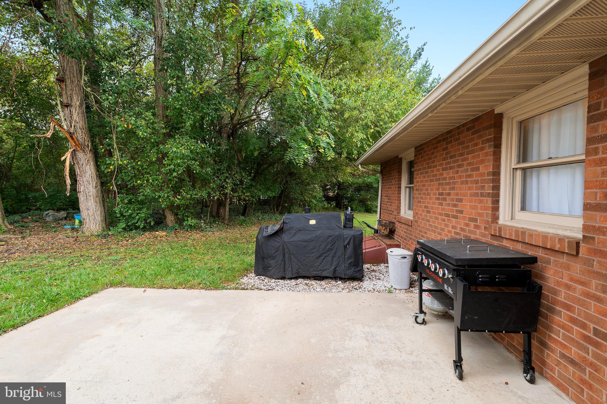 1414 Kitchens Orchard Falling Waters, WV 25419 - Photo 8 of 55 a backyard of a house with table and chairs