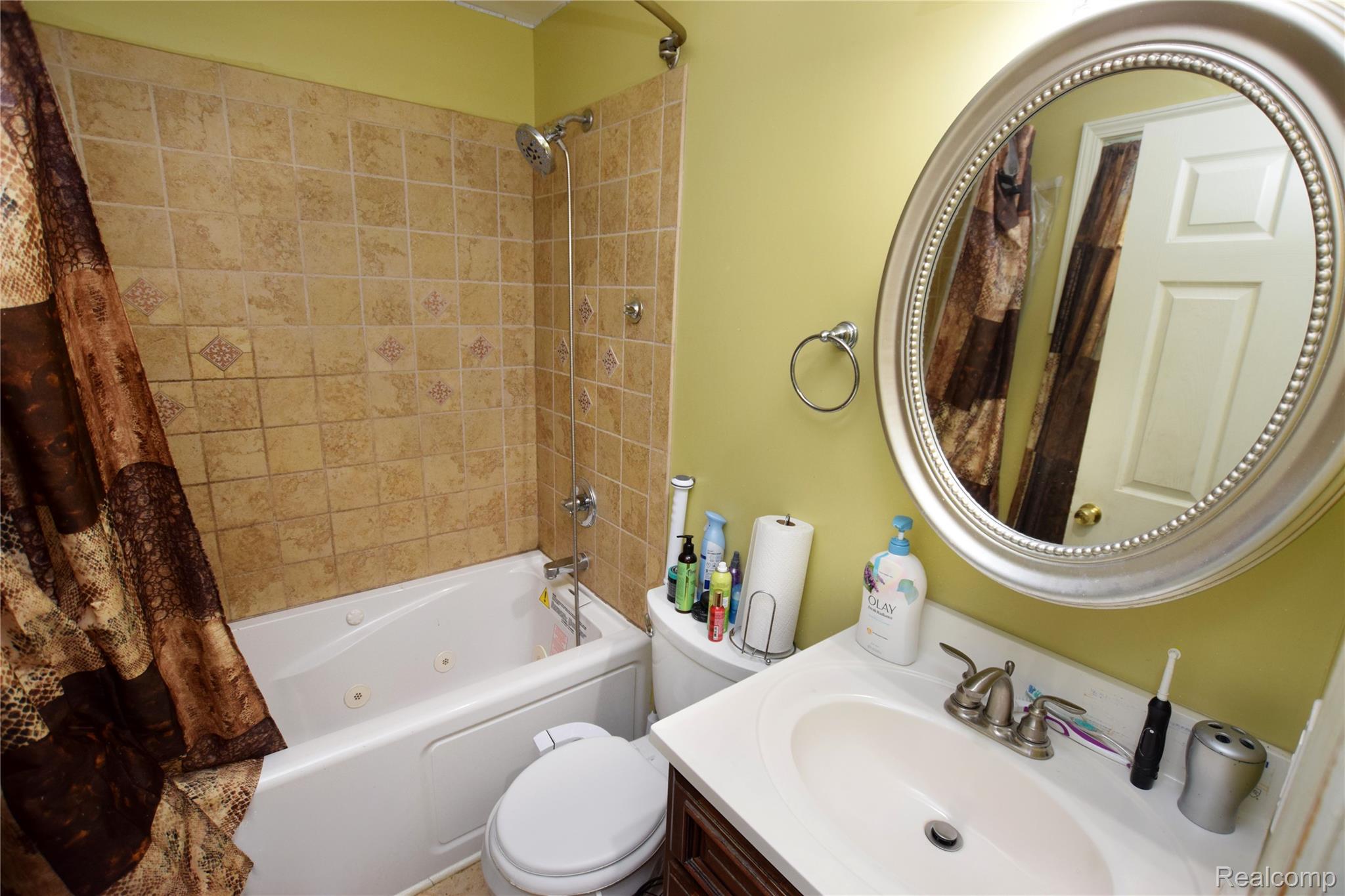 4301 Pengelly Road Flint, MI 48507 - Photo 9 of 16 Full bathroom with a combined bath / shower with jetted tub and vanity