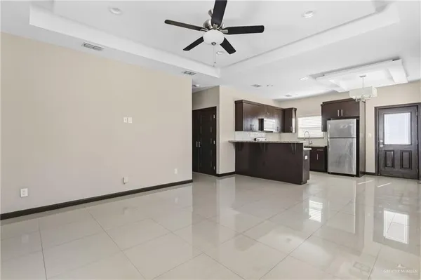 a large kitchen with cabinets and stainless steel appliances