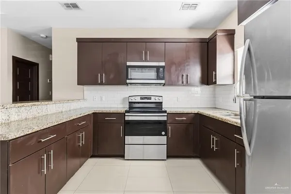 a kitchen with a sink and a stove top oven