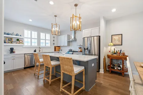 a kitchen with granite countertop cabinets stainless steel appliances and a center island