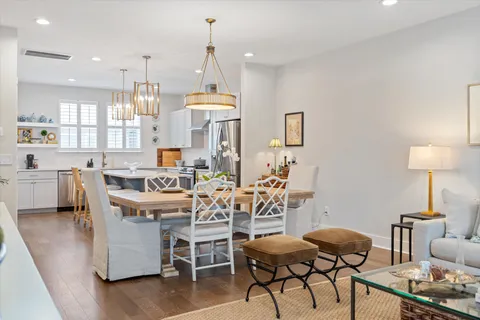 a dining room with furniture and a chandelier