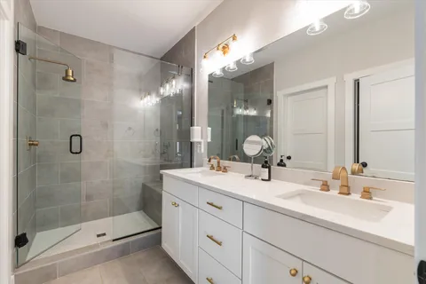 a bathroom with a shower sink and mirror
