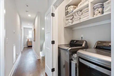 a view of a hallway with workspace and wooden floor