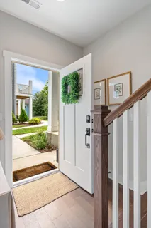 a view of a porch with furniture and a yard