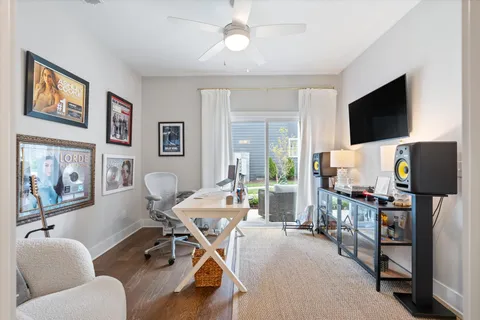 a view of a livingroom with furniture and a flat screen tv