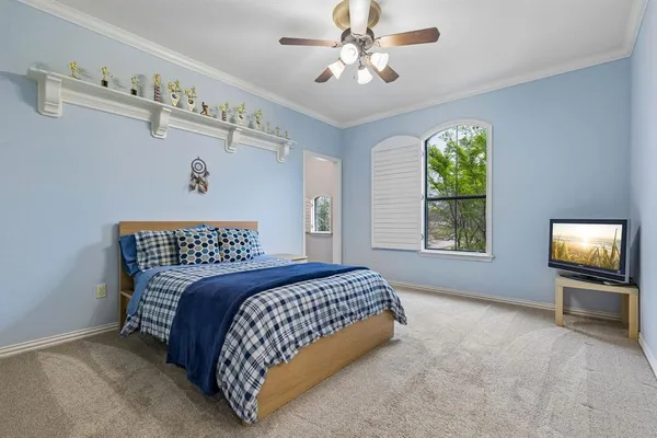 a spacious bedroom with a bed and a chandelier