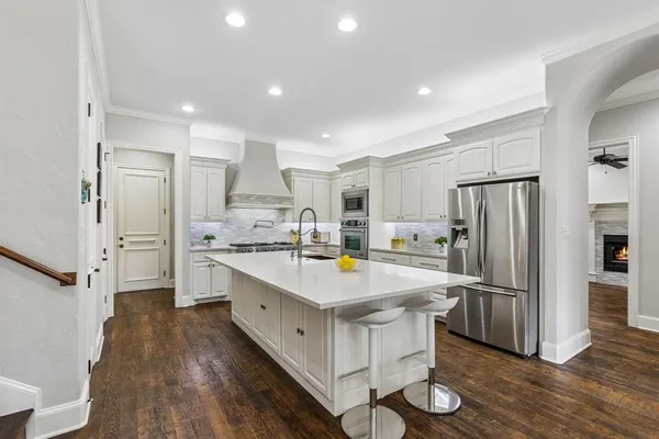 a kitchen with stainless steel appliances a refrigerator sink and stove