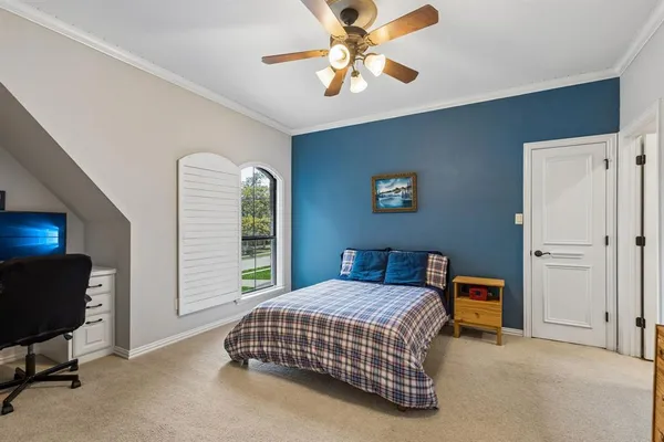 a bedroom with a bed and a chandelier