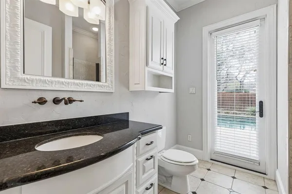 a bathroom with a granite countertop sink a toilet and bathtub
