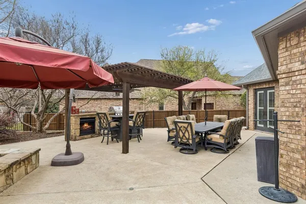a view of a chairs and table in patio with a barbeque grill
