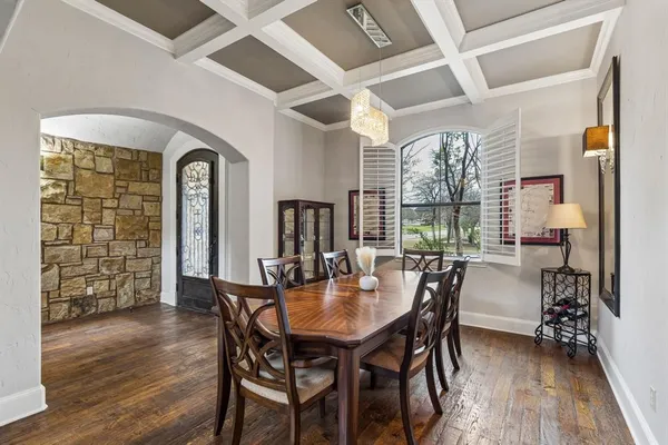 a dining room with furniture window and wooden floor