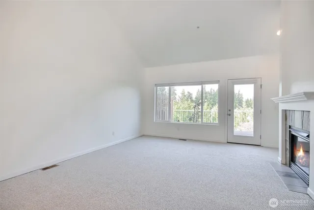 a view of empty room with a fireplace