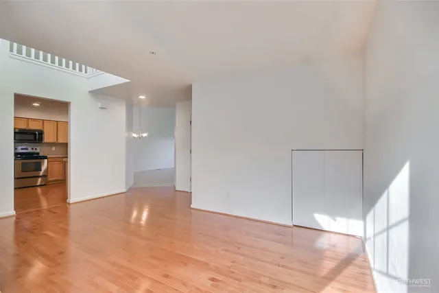 a view of empty room with wooden floor