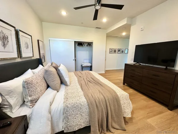 a bedroom with a bed and a flat screen tv