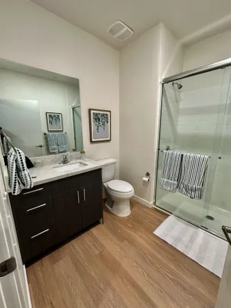 a spacious bathroom with a double vanity sink and a mirror